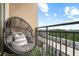 Inviting balcony featuring a cozy chair, decorative lanterns, and a picturesque neighborhood view at 711 Cosmopolitan Ne Dr # 625, Atlanta, GA 30324