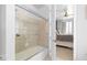 Bright bathroom featuring a shower with glass doors and a partial view of the Primary bedroom at 711 Cosmopolitan Ne Dr # 625, Atlanta, GA 30324