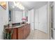 Bathroom with a dark vanity, granite countertop, and three doors that offer a clean and spacious design at 711 Cosmopolitan Ne Dr # 625, Atlanta, GA 30324