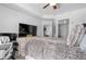 Bright bedroom with a ceiling fan, a comfortable bed, and a work area next to the window at 711 Cosmopolitan Ne Dr # 625, Atlanta, GA 30324