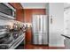 Modern kitchen showcasing stainless steel appliances, wood cabinets, and sleek countertops at 711 Cosmopolitan Ne Dr # 625, Atlanta, GA 30324