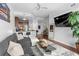 Open-concept living area with a comfortable gray sofa, sleek ceiling fan, and a modern kitchen backdrop at 711 Cosmopolitan Ne Dr # 625, Atlanta, GA 30324