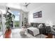 Sunlit living room featuring hardwood floors, modern furnishings, and a balcony with a view at 711 Cosmopolitan Ne Dr # 625, Atlanta, GA 30324