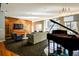 Modern lounge with piano, multiple seating areas, TV, wood paneling, and natural light at 711 Cosmopolitan Ne Dr # 625, Atlanta, GA 30324