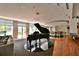 Comfortable lounge with baby grand piano, bar area, and seating with natural light at 711 Cosmopolitan Ne Dr # 625, Atlanta, GA 30324
