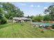 A lush backyard with an in-ground pool and plenty of green space for outdoor activities and entertaining at 962 Brighton Dr, Lawrenceville, GA 30043