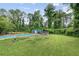 Expansive backyard with a swimming pool, storage shed, and lots of green space, perfect for Gathering fun at 962 Brighton Dr, Lawrenceville, GA 30043