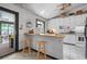 Bright, eat-in kitchen featuring white cabinetry, and bar seating providing a great space for cooking and gathering at 962 Brighton Dr, Lawrenceville, GA 30043