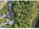 Aerial view of the property showcasing its location amidst lush greenery, with a red outline highlighting the home's boundaries at 112 Birchwood Pass, Canton, GA 30114