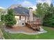 Expansive backyard featuring a large wooden deck, lush green lawn, and mature trees, perfect for outdoor living at 112 Birchwood Pass, Canton, GA 30114