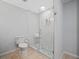 Modern bathroom featuring glass enclosed shower with white tile and hexagon floor tile at 112 Birchwood Pass, Canton, GA 30114