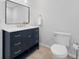 Bathroom vanity with a quartz countertop, classic mirror, and chrome hardware at 112 Birchwood Pass, Canton, GA 30114