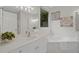 A bright bathroom featuring a soaking tub, quartz countertops, and neutral paint at 112 Birchwood Pass, Canton, GA 30114
