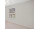 A bedroom with white carpet and walls, a ceiling fan, and white window shutters at 112 Birchwood Pass, Canton, GA 30114