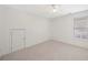 An empty carpeted bedroom featuring a ceiling fan and a window with blinds at 112 Birchwood Pass, Canton, GA 30114
