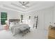A main bedroom featuring a trey ceiling, neutral walls, white carpet, and a bright exterior view at 112 Birchwood Pass, Canton, GA 30114