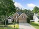 Traditional brick home with lush front lawn and two-car garage at 112 Birchwood Pass, Canton, GA 30114