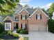 Beautiful brick home with a well-maintained yard and two-car garage at 112 Birchwood Pass, Canton, GA 30114