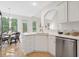 Modern kitchen with bright white cabinets, stainless steel appliances, and hardwood floors at 112 Birchwood Pass, Canton, GA 30114