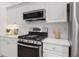 Modern kitchen featuring stainless steel appliances, white cabinets, and a modern oven range at 112 Birchwood Pass, Canton, GA 30114