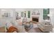 Sunlit living room with a cozy fireplace, hardwood flooring, and views of the outdoors from multiple windows at 112 Birchwood Pass, Canton, GA 30114