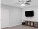 A living room featuring a large television, a console table, and a ceiling fan at 112 Birchwood Pass, Canton, GA 30114