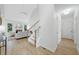 Bright living room featuring hardwood floors, fireplace, and staircase at 112 Birchwood Pass, Canton, GA 30114