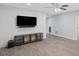 Open living room with wood flooring, shiplap accent wall, and modern ceiling fan at 112 Birchwood Pass, Canton, GA 30114