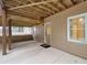 Covered patio with a concrete floor, support beams, an exterior door, and a view of the backyard at 112 Birchwood Pass, Canton, GA 30114
