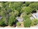 Aerial view of a home surrounded by mature trees in a wooded lot with neighboring homes at 170 Mayfield Cir, Alpharetta, GA 30009