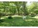Expansive backyard features a lush lawn and mature trees, perfect for outdoor activities at 170 Mayfield Cir, Alpharetta, GA 30009