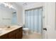 Traditional bathroom featuring a vanity, toilet, shower with blue curtain, and a medicine cabinet at 170 Mayfield Cir, Alpharetta, GA 30009