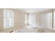 Bright bedroom with built-in window seats, neutral walls, plush carpeting, and closet with bifold doors at 170 Mayfield Cir, Alpharetta, GA 30009