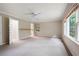 Spacious, carpeted bedroom featuring a ceiling fan and natural light at 170 Mayfield Cir, Alpharetta, GA 30009