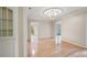 Elegant dining room with hardwood floors, crown molding, and a stylish chandelier at 170 Mayfield Cir, Alpharetta, GA 30009