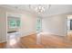 Light filled room with hardwood floors, molding and many windows overlooking greenery at 170 Mayfield Cir, Alpharetta, GA 30009