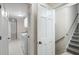 Hallway featuring a stairwell leading to a laundry room area at 170 Mayfield Cir, Alpharetta, GA 30009