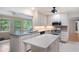 Cozy kitchen featuring bright windows, a kitchen island, stainless steel appliances and white cabinets at 170 Mayfield Cir, Alpharetta, GA 30009