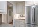 Close-up view of a kitchen featuring stainless steel refrigerator, sink, and white cabinets at 170 Mayfield Cir, Alpharetta, GA 30009