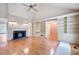 Spacious living room with hardwood floors, fireplace, built-in shelving, and vaulted ceilings at 170 Mayfield Cir, Alpharetta, GA 30009