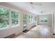 Bright sunroom with multiple windows offering views of the lush, wooded surroundings at 170 Mayfield Cir, Alpharetta, GA 30009