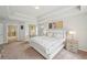 Bright main bedroom featuring tray ceilings, neutral tones, and comfortable furniture at 2100 Baywood Sw Blvd, Austell, GA 30106