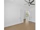 Neutral bedroom with French doors, hardwood flooring, and a modern ceiling fan at 6520 Pond View Dr, Cumming, GA 30028