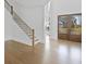 Entryway featuring hardwood floors, a staircase, and double doors with views of the outdoors at 6520 Pond View Dr, Cumming, GA 30028