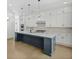 Modern kitchen with white cabinetry, stainless steel appliances, and a large island at 6520 Pond View Dr, Cumming, GA 30028
