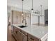 Modern kitchen with hardwood flooring, stainless steel appliances, and a large center island at 6520 Pond View Dr, Cumming, GA 30028