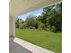 Covered patio overlooking a spacious backyard with mature trees at 6520 Pond View Dr, Cumming, GA 30028