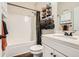 Neat bathroom with a shower-tub, a single sink, and organized towel storage for a tidy space at 79 Little Creek Manor Dr, Dallas, GA 30157