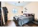 Cozy bedroom with dark wood floors, black furniture, and ample natural light at 79 Little Creek Manor Dr, Dallas, GA 30157