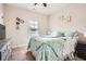Cozy bedroom with a queen-sized bed, a window offering natural light, and a ceiling fan at 79 Little Creek Manor Dr, Dallas, GA 30157